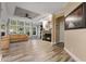Bright living room with a cozy fireplace, large windows, and comfortable leather seating at 227 N Putnam Grove Rd, Oak Hill, FL 32759