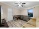 The living room features a window view, laminate flooring, a couch, and a foosball table at 227 N Putnam Grove Rd, Oak Hill, FL 32759