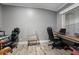 Bright home office with hardwood floors, a large window, gaming chairs and a workspace perfect for productivity at 227 N Putnam Grove Rd, Oak Hill, FL 32759