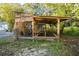 Rabbit hutch exterior nestled among mature landscaping at 227 N Putnam Grove Rd, Oak Hill, FL 32759