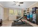 Organized storage room with shelves, bins, a deep freezer, a safe, a weight bench and wood laminate flooring at 227 N Putnam Grove Rd, Oak Hill, FL 32759