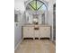 Bright bathroom featuring dual vanities, a large window, and a neutral color scheme at 1083 E Normandy Blvd, Deltona, FL 32725