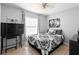 Bedroom featuring a comfortable bed with patterned linens, neutral walls and a ceiling fan at 1083 E Normandy Blvd, Deltona, FL 32725