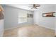 Simple bedroom featuring tile floors, a ceiling fan, and neutral walls and blinds at 1083 E Normandy Blvd, Deltona, FL 32725