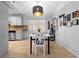 Cozy dining area with a modern light fixture, adjacent to the kitchen at 1083 E Normandy Blvd, Deltona, FL 32725