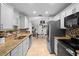 Modern kitchen featuring granite countertops, stainless steel appliances, and ample cabinet space at 1083 E Normandy Blvd, Deltona, FL 32725