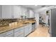 Well-lit kitchen with granite counters, tile backsplash, and stainless steel dishwasher at 1083 E Normandy Blvd, Deltona, FL 32725