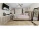 Inviting main bedroom featuring a tufted headboard, neutral tones, and modern decor at 1083 E Normandy Blvd, Deltona, FL 32725