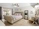 Serene main bedroom with a tufted headboard, neutral tones, and sliding glass doors at 1083 E Normandy Blvd, Deltona, FL 32725