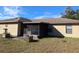 Rear exterior view of house, includes a screened in porch and backyard at 1201 Buccaneer Ave, Deltona, FL 32725