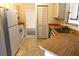 Efficient kitchen with white cabinets and wood-look countertops at 1201 Buccaneer Ave, Deltona, FL 32725