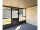 This is a screened porch with a gray floor and access to the backyard at 1201 Buccaneer Ave, Deltona, FL 32725