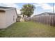 Fenced backyard with grassy area and wooden gate at 1267 Saxon Blvd, Deltona, FL 32725