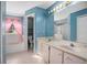 Bathroom features a double vanity, tub, and separate shower at 1267 Saxon Blvd, Deltona, FL 32725