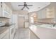 View of the kitchen with white appliances and a large window at 1267 Saxon Blvd, Deltona, FL 32725