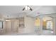 Open-concept living and kitchen area with high ceilings and ceiling fans at 1267 Saxon Blvd, Deltona, FL 32725