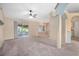 Spacious living room with carpet flooring and sliding glass doors at 1267 Saxon Blvd, Deltona, FL 32725