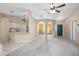 Open-concept living and kitchen area with high ceilings and ceiling fans at 1267 Saxon Blvd, Deltona, FL 32725