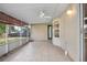 Spacious screened porch with ceiling fan and tiled floor at 1267 Saxon Blvd, Deltona, FL 32725