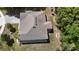 An aerial view of a large home with a gray roof, lush trees, and a well-maintained green lawn at 1600 Lady Fern Trl, Deland, FL 32720