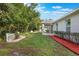 Large backyard featuring plush green grass, trimmed hedges, and a white picket fence at 1600 Lady Fern Trl, Deland, FL 32720