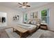 Bright bedroom featuring neutral walls, ceiling fan, carpet floors, and abundant natural light at 1600 Lady Fern Trl, Deland, FL 32720