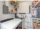 Practical laundry area featuring a washing machine, water heater, and storage shelves at 225 N Hill Ave # 60, Deland, FL 32724