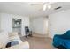 Living room features a comfortable off-white couch, rocking chair, and a view into the kitchen area at 225 N Hill Ave # 60, Deland, FL 32724