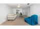 Bright living room with carpet, ceiling fan, and views into the kitchen at 225 N Hill Ave # 60, Deland, FL 32724