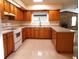 A bright kitchen with wooden cabinets, tile floors and modern appliances at 641 Fairhaven St, Deltona, FL 32725