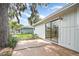 Exterior view showcasing the back patio with sliding glass doors and yard at 779 Victoria E Cir, Ormond Beach, FL 32174