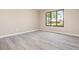 Bedroom with modern flooring, neutral paint, and a window overlooking the neighborhood at 779 Victoria E Cir, Ormond Beach, FL 32174
