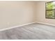 Well-lit bedroom with wood-style floors, freshly painted walls, and a large window for natural light at 779 Victoria E Cir, Ormond Beach, FL 32174