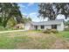 Spacious home featuring a large front yard and attached two-car garage at 779 Victoria E Cir, Ormond Beach, FL 32174