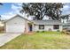 Charming single-story home featuring a well-manicured lawn and an attached two-car garage at 779 Victoria E Cir, Ormond Beach, FL 32174