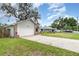 Well-maintained home showcasing a two-car garage and mature trees at 779 Victoria E Cir, Ormond Beach, FL 32174