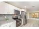 Updated kitchen featuring stainless steel appliances and granite countertops at 779 Victoria E Cir, Ormond Beach, FL 32174