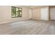 Spacious living room featuring stylish light grey flooring, large windows, and a freshly painted interior at 779 Victoria E Cir, Ormond Beach, FL 32174