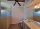 Well-lit bathroom with tan tile flooring and glass-door shower with seat at 821 Wingate Trl, Port Orange, FL 32128