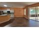 Dining area with sliding doors, chandelier, and adjacent eat-in kitchen at 821 Wingate Trl, Port Orange, FL 32128