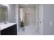 Clean bathroom boasts a bathtub, double vanity, and updated tile at 855 E Church St, Deland, FL 32724