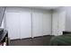 Bedroom with ample closet space and dark hardwood floors at 855 E Church St, Deland, FL 32724