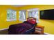 Bright bedroom with yellow walls and a full bed at 855 E Church St, Deland, FL 32724