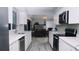 Modern kitchen with white cabinets, stainless steel appliances, and granite countertops at 855 E Church St, Deland, FL 32724