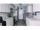 Modern kitchen with white cabinets, stainless steel appliances, and granite countertops at 855 E Church St, Deland, FL 32724