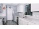 Modern kitchen with white cabinets, stainless steel appliances, and granite countertops at 855 E Church St, Deland, FL 32724