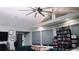Living room with teal sectional sofa, large windows, and extensive media collection at 855 E Church St, Deland, FL 32724