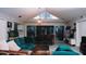 Bright living room with vaulted ceilings, teal sectional sofa, and dining area at 855 E Church St, Deland, FL 32724