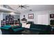 Spacious living room with teal sectional sofa and built-in shelving at 855 E Church St, Deland, FL 32724