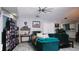 Spacious living room featuring a teal sectional sofa and large media collection at 855 E Church St, Deland, FL 32724